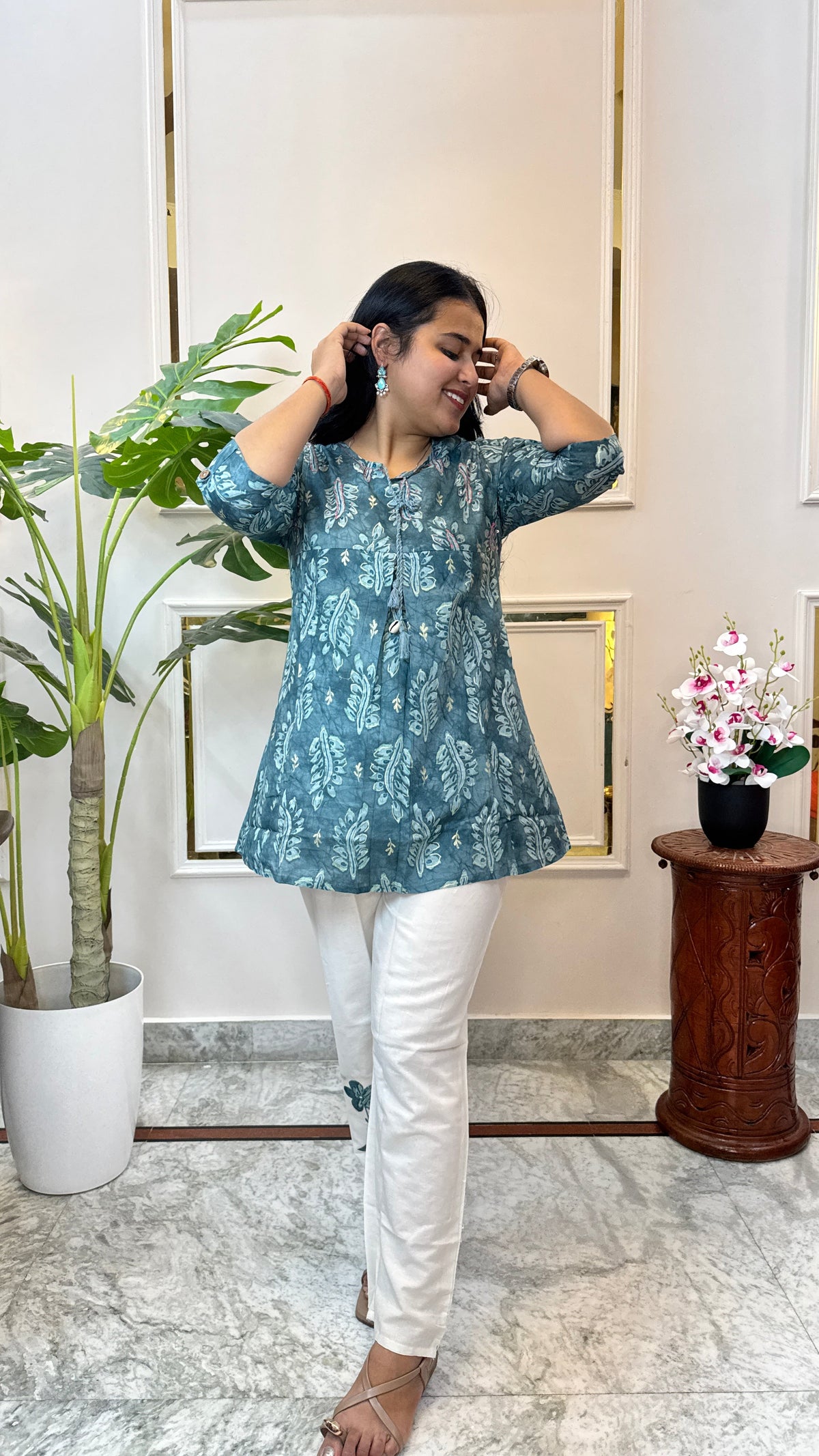 Teal batik print kurti and white pant co-ord set shown in movement