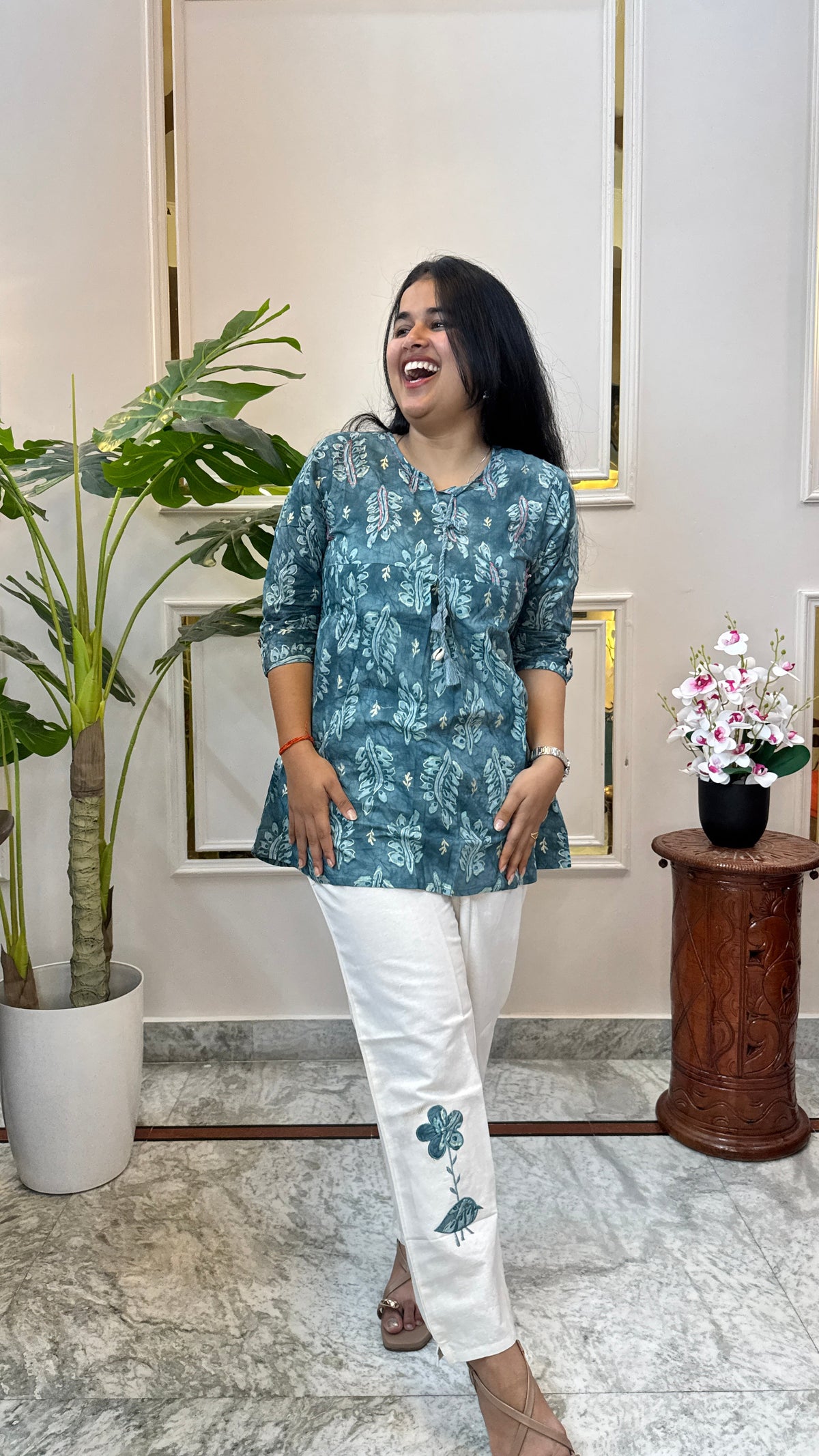 Full look of the Brisora teal batik print kurti and white pant set for women