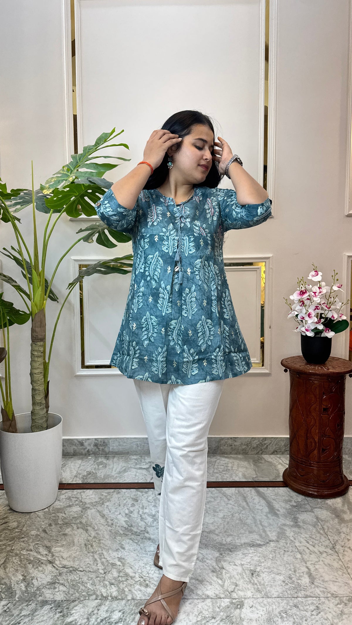 Side angle of the teal batik kurti showing its A-line flare and roll-up sleeves