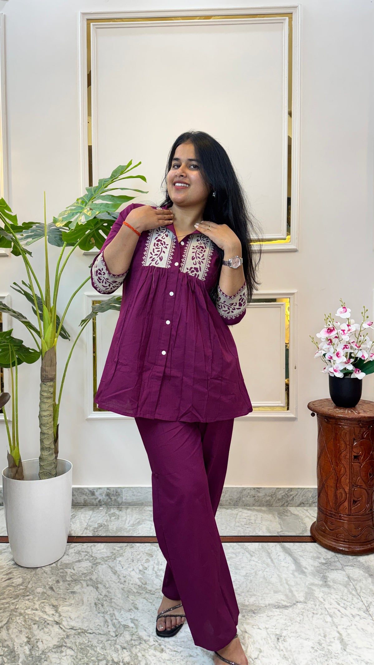 Close view of the cream floral vine print panels and white buttons on the kurti yoke