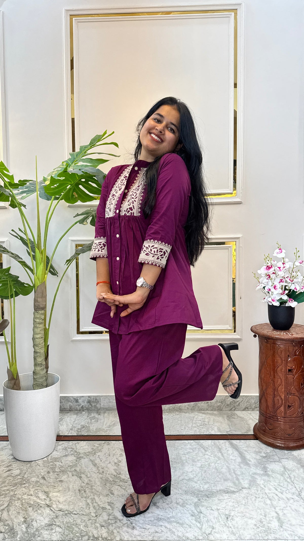 Side view of the wine purple kurti set styled with black heels